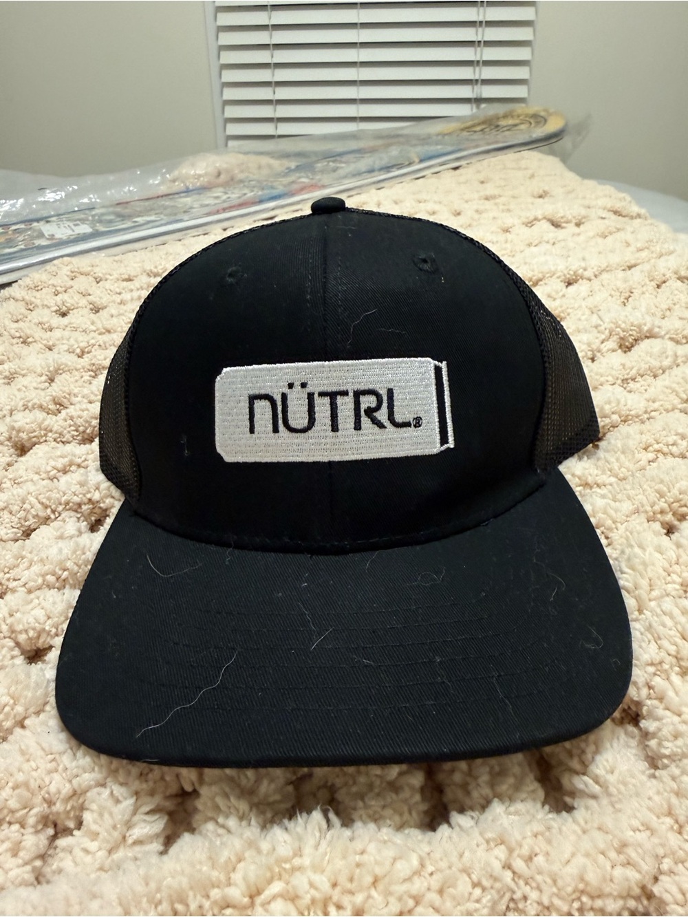 NÜTRL Black Trucker Hat with White Patch Logo